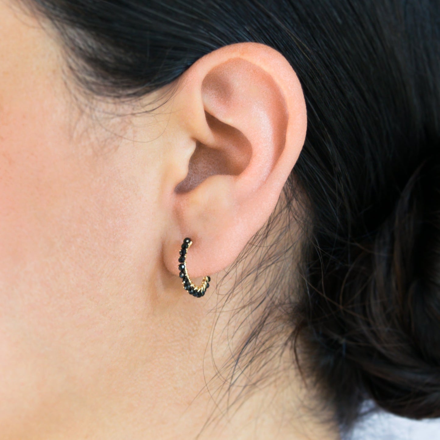 14k gold-filled wire hand formed into a mini rounded hoop with micro faceted natural black spinel beads wire wrapped throughout.