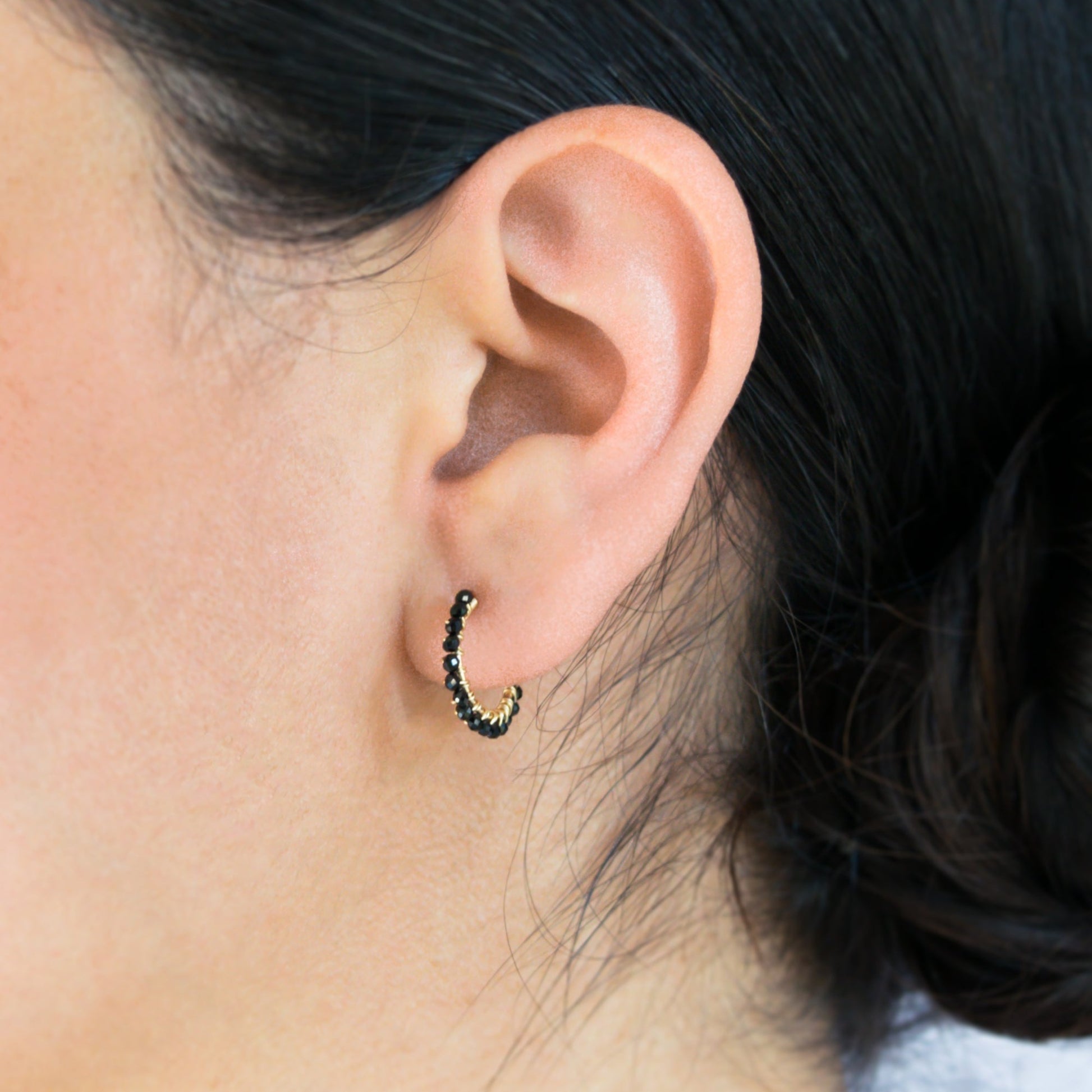 14k gold-filled wire hand formed into a mini rounded hoop with micro faceted natural black spinel beads wire wrapped throughout.