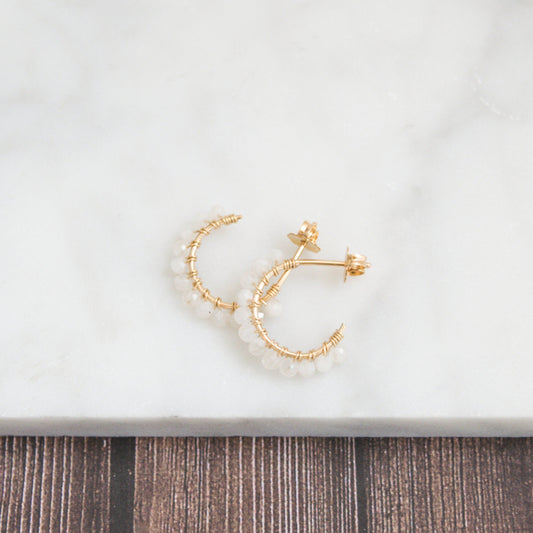 Hand-formed 14k gold-filled wire gracefully shaped into mini rounded hoops. Delicately strung with micro-faceted natural rainbow moonstone beads, these mini hoops add a polished finish to any outfit.