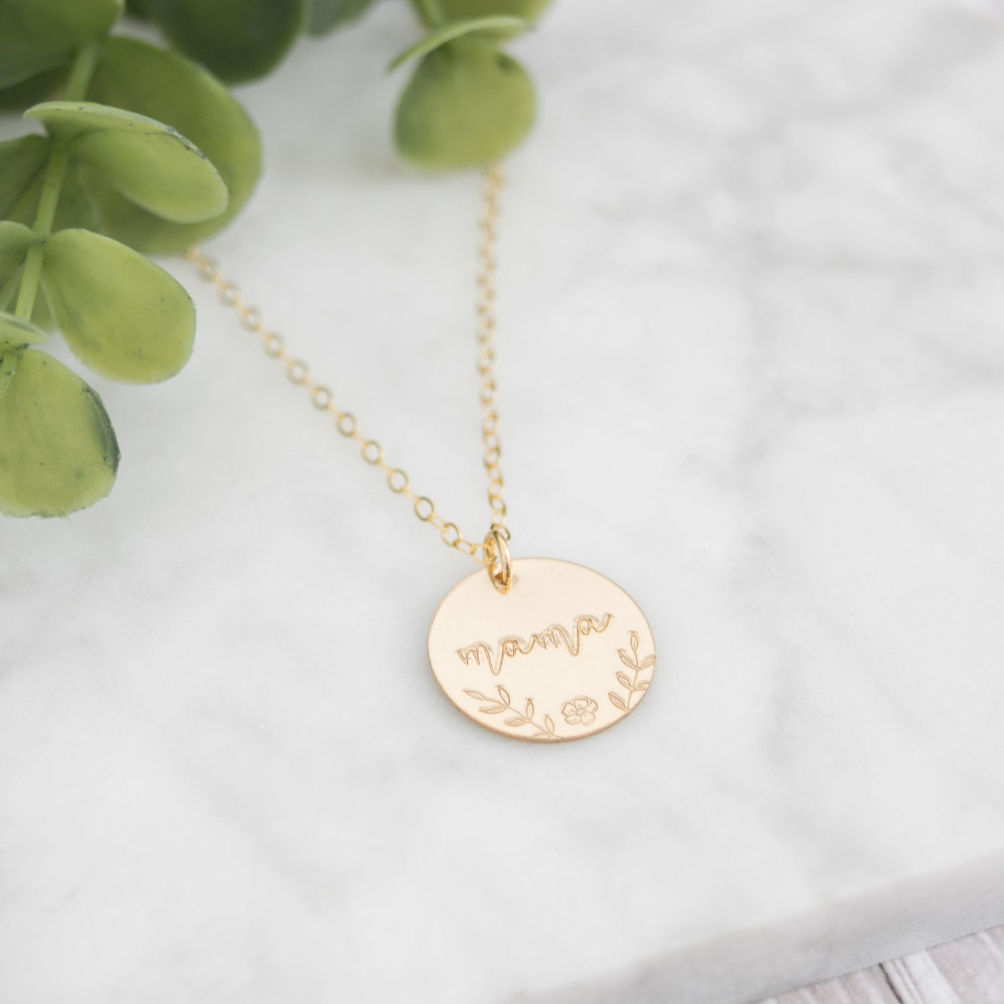 Large 5/8" disc stamped with "mama" in a beautiful script decorated with hand stamped florals along the bottom border.