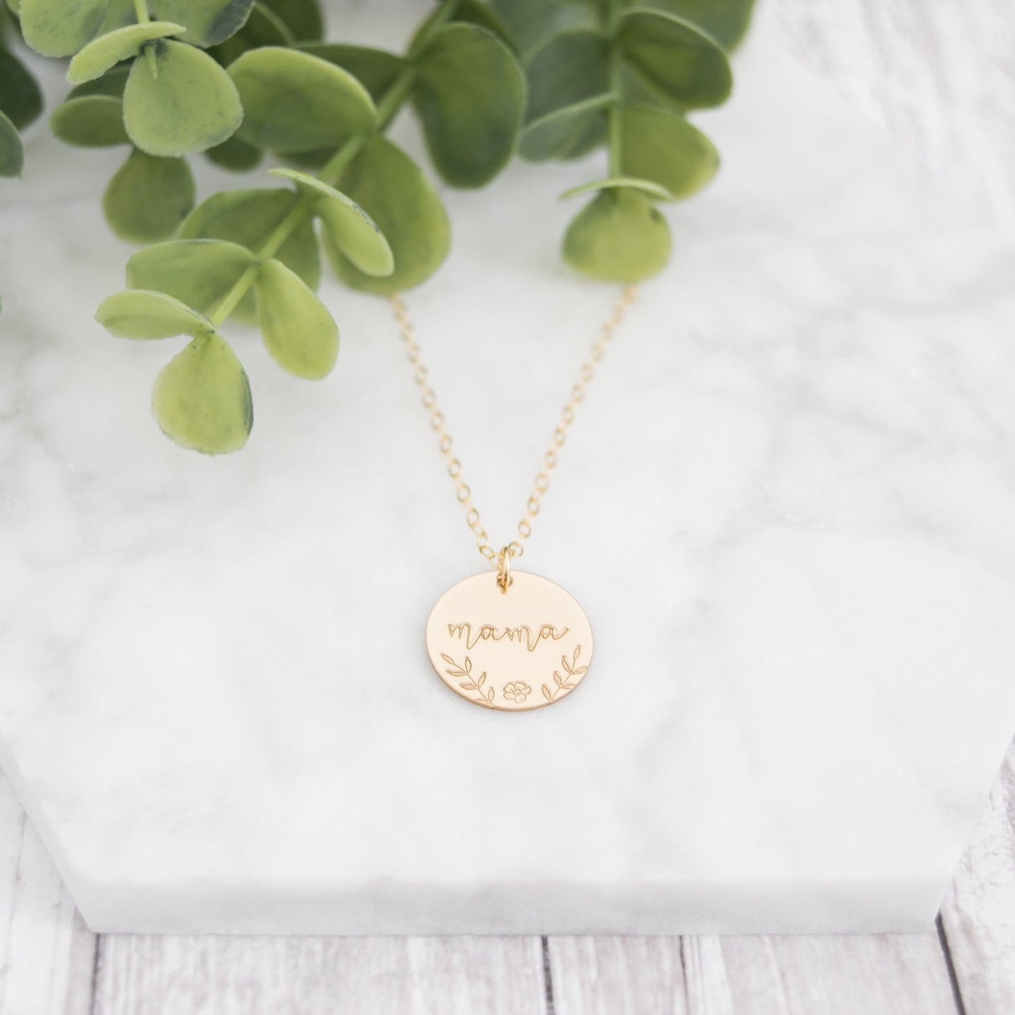 Large 5/8" disc stamped with "mama" in a beautiful script decorated with hand stamped florals along the bottom border.