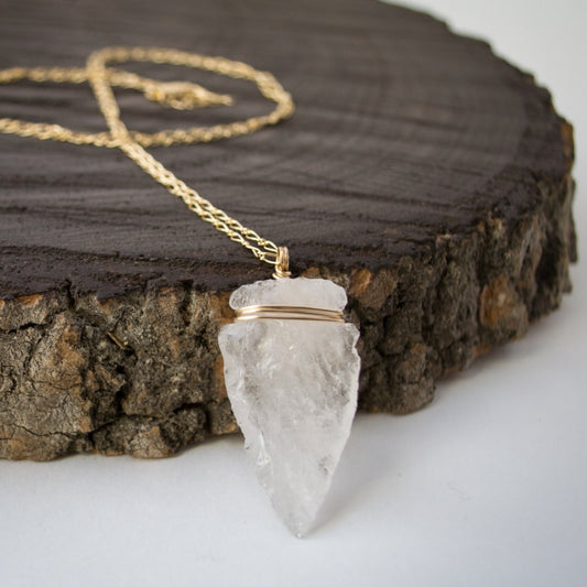 Elevate your style with the Althea Quartz Crystal Necklace, featuring a hand-knapped natural quartz crystal arrowhead on a 14k gold-filled curb figaro chain.