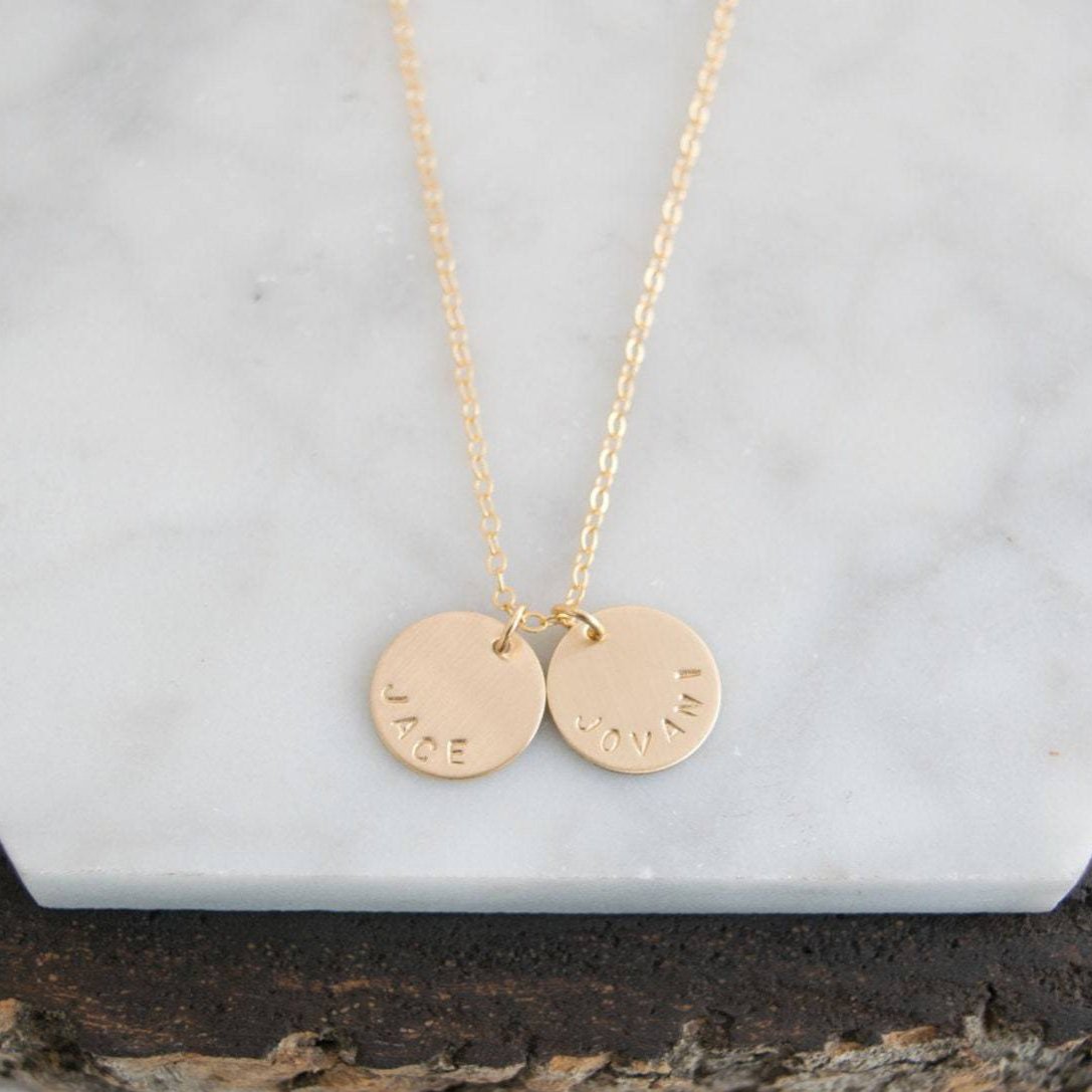 Customize your look with the Aster 1/2" Disc Name Necklace, a minimalist 14K gold-filled or sterling silver disc necklace delicately hand-stamped with a name, message, initials, or date of your choice.