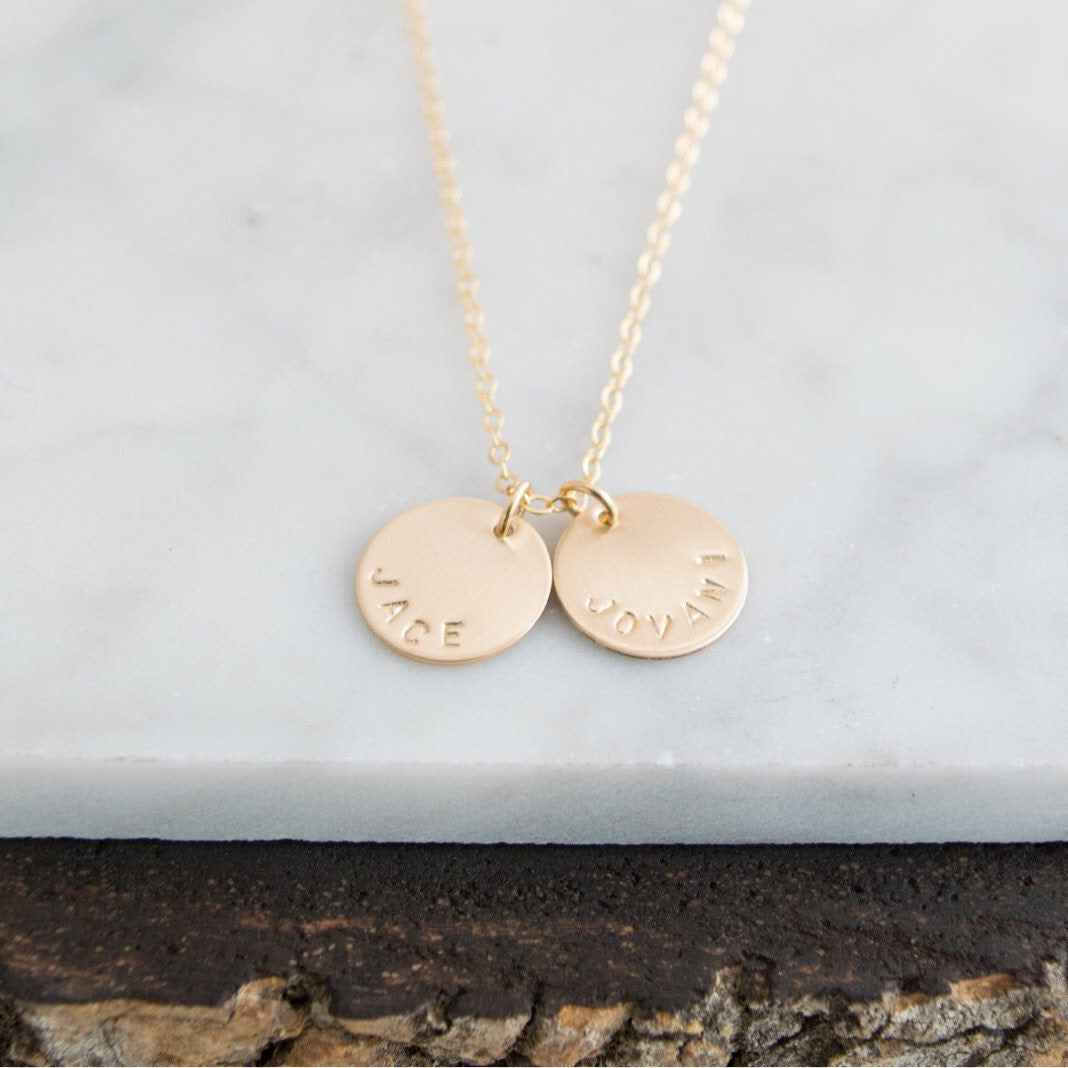 Customize your look with the Aster 1/2" Disc Name Necklace, a minimalist 14K gold-filled or sterling silver disc necklace delicately hand-stamped with a name, message, initials, or date of your choice.