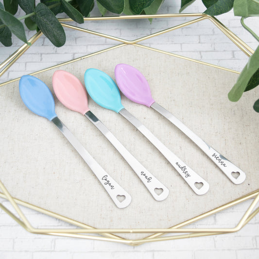 Personalized colorful baby spoon set. Set comes with two spoons that are hand stamped with baby name of choice. Spoon comes with heart cut out at end of handle.