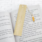 Personalized Teacher Brass Bookmark with pencil charm on a book