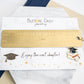 Personalized graduation bookmark displayed on a card reading “Enjoy the next chapter!”