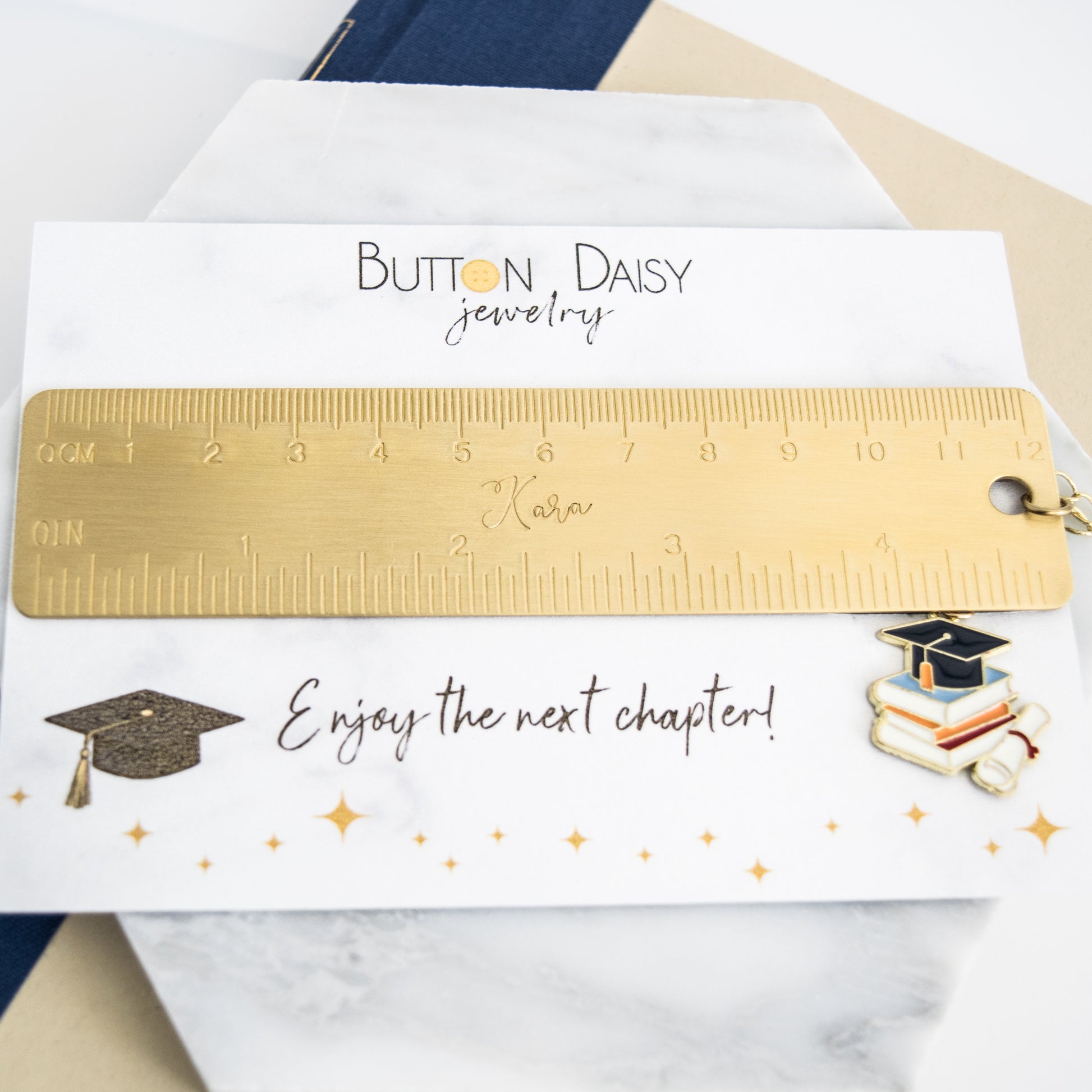 Personalized graduation bookmark displayed on a card reading “Enjoy the next chapter!”