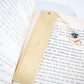 Personalized brass graduation bookmark with hand-stamped name and graduation cap charm.