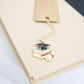 Personalized brass graduation bookmark with hand-stamped name and graduation cap charm.