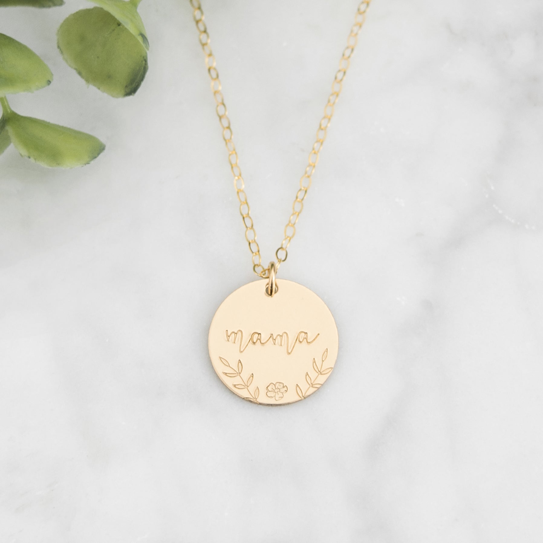 Large 5/8" disc stamped with "mama" in a beautiful script decorated with hand stamped florals along the bottom border.