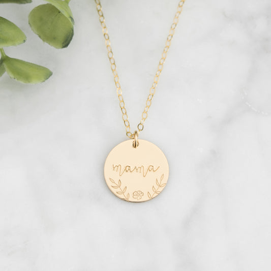 Large 5/8" disc stamped with "mama" in a beautiful script decorated with hand stamped florals along the bottom border.