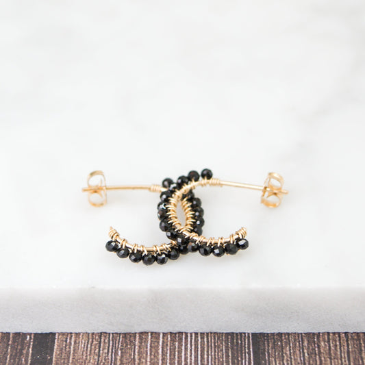 14k gold-filled wire hand formed into a mini rounded hoop with micro faceted natural black spinel beads wire wrapped throughout.