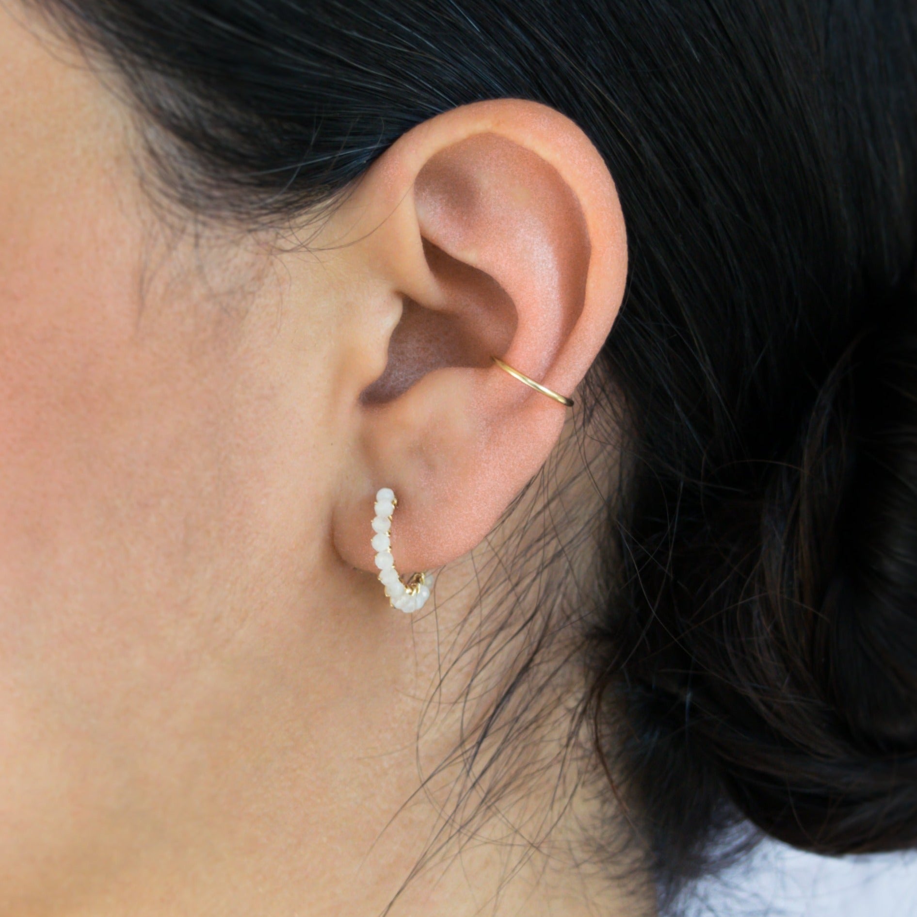 Cuff hoop earring in 14k gold-fill on model styled with Moonstone hoop earrings