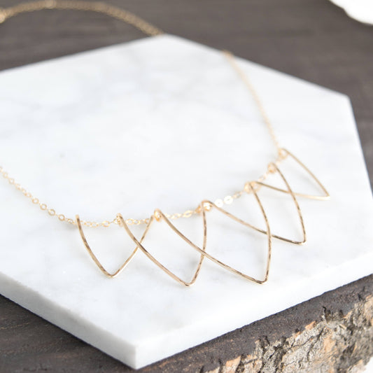 Sophisticated Hilary Curved Triangle Necklace - Geometric Handmade Jewelry. Five interlocking hammered V-shaped curved triangle wire necklace in 14k gold-fill materials
