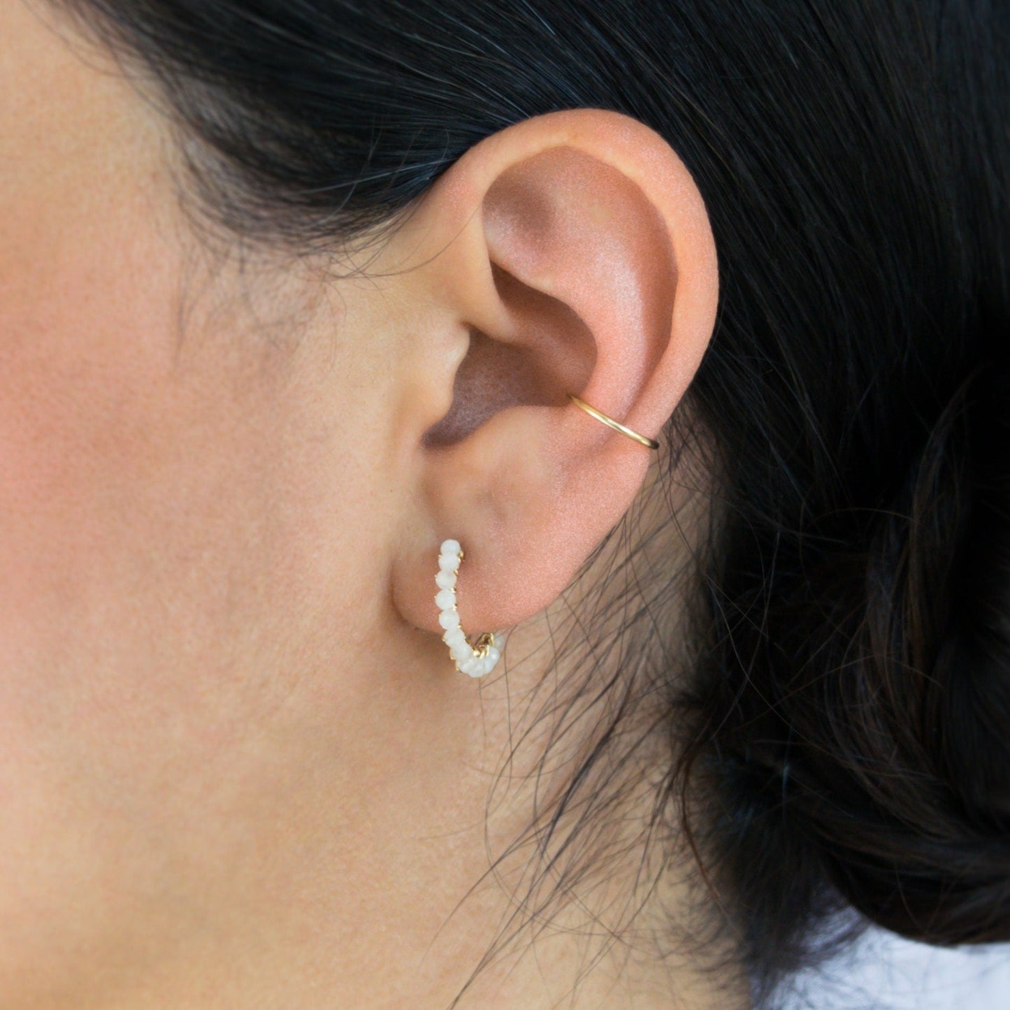 Hand-formed 14k gold-filled wire gracefully shaped into mini rounded hoops. Delicately strung with micro-faceted natural rainbow moonstone beads, these mini hoops add a polished finish to any outfit.