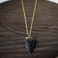 A hand-knapped obsidian arrowhead suspended on a curb figaro chain crafted in your choice of 14k gold-filled or sterling silver, hand-wrapped with corresponding wire, exuding clean elegance.