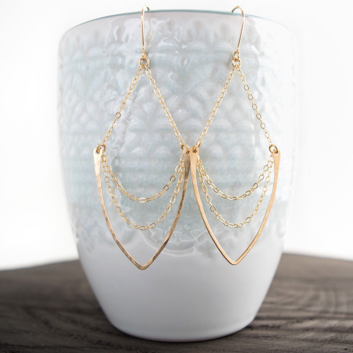 Multi-chain chandelier earrings featuring hammered v-shaped pendant suspended on a 14k gold-filled or sterling silver cable chain. These earrings dangle freely on hand-forged French ear wires.