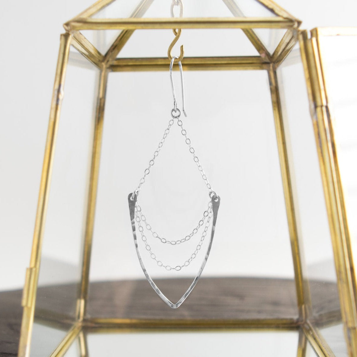 Multi-chain chandelier earrings featuring hammered v-shaped pendant suspended on a 14k gold-filled or sterling silver cable chain. These earrings dangle freely on hand-forged French ear wires.